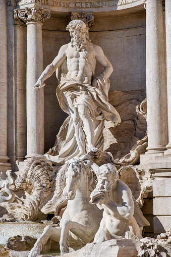 The detail of the monumental statue of the Ocean, by the sculptor Pietro Bracci (1700-1773), in the center of the majestic Trevi Fountain, in the historic center of Rome. Built in 1732 on the wishes of Pope Clement XII, the Trevi Fountain it's one of the masterpiece of the late Roman Baroque, recognized as one of the most beautiful and famous fountain in the world. Built on the facade of the Palazzo Poli by the architect Nicola Salvi, it was inaugurated in 1762. Image in High Definition format.
