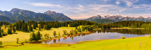 istock panoramic landscape with mountain range in Bavaria at springtime 1302646218