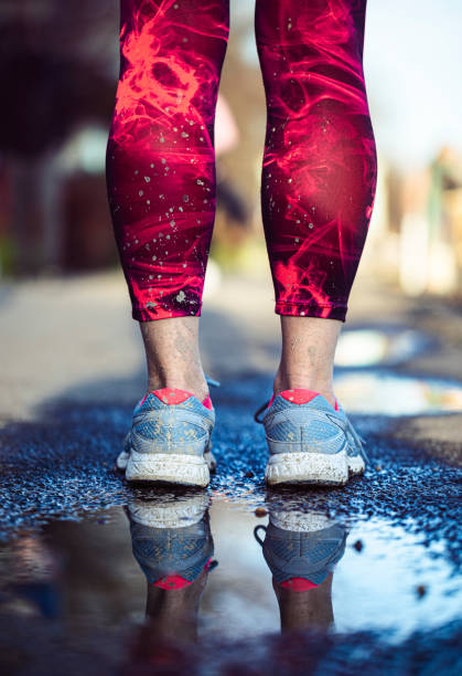 istock Muddy legs and sneakers after the run 1302646501