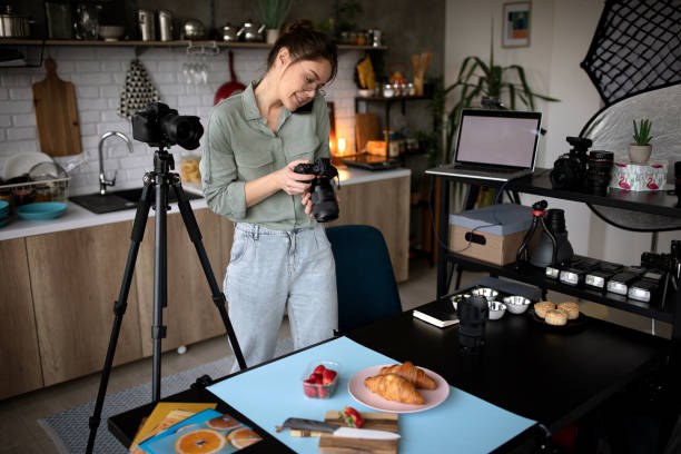 istock Young photographer multitasking in her home studio office 1302647739