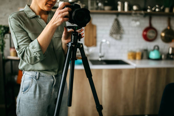 istock Young female photographer seting up her camera 1302647752