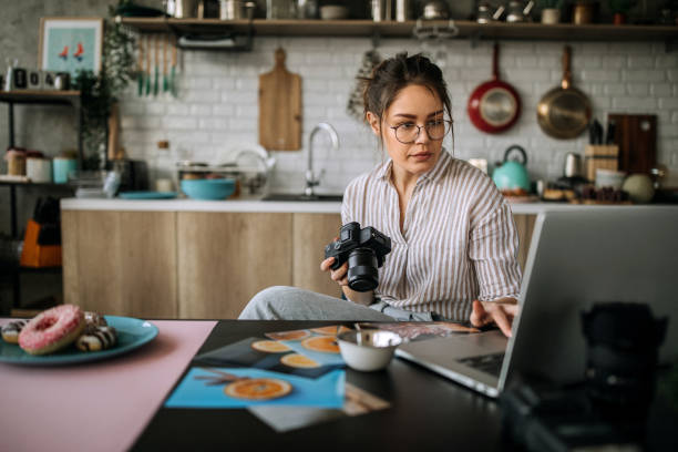 Young female photographer working in her home office studio Young female food photographer working process editor photos stock pictures, royalty-free photos & images