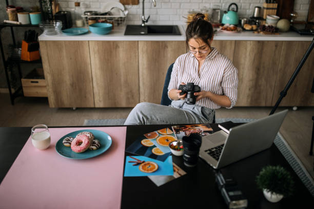 istock Young female photographer working in her home office studio 1302647892