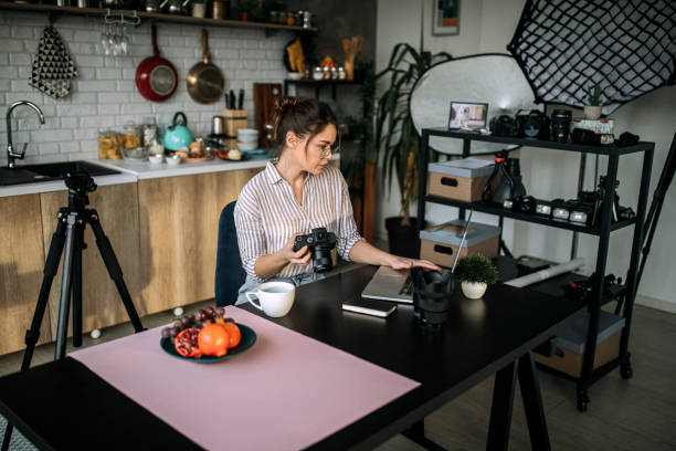 istock Female photographer working in her home office studio 1302648109