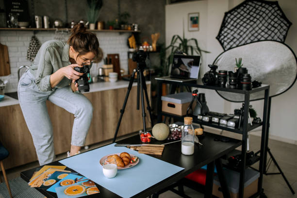 istock Young female food photographer in work 1302648180