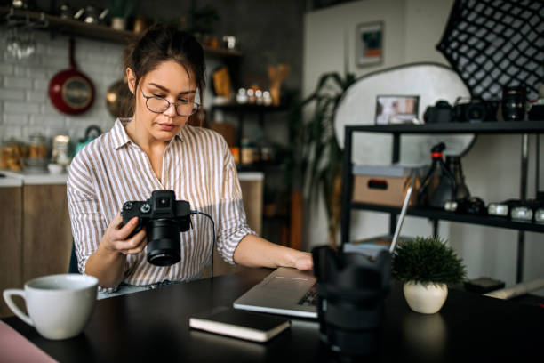 istock Female photographer working in her home office studio 1302648714