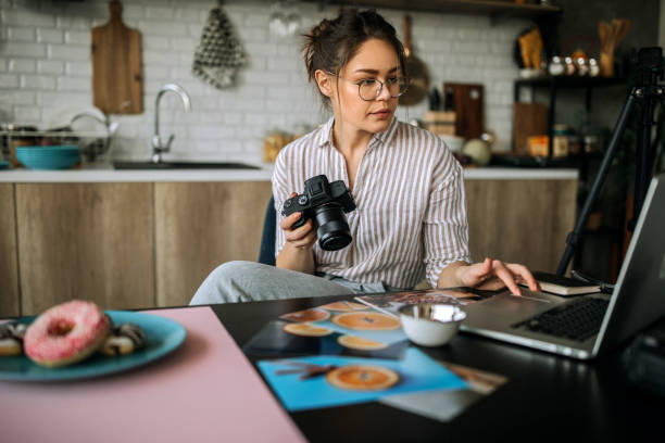 istock Young female photographer working in her home office studio 1302648731