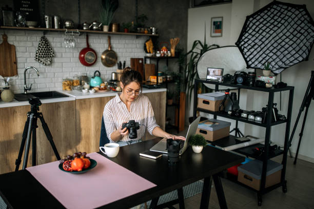 istock Female photographer working in her home office studio 1302648863