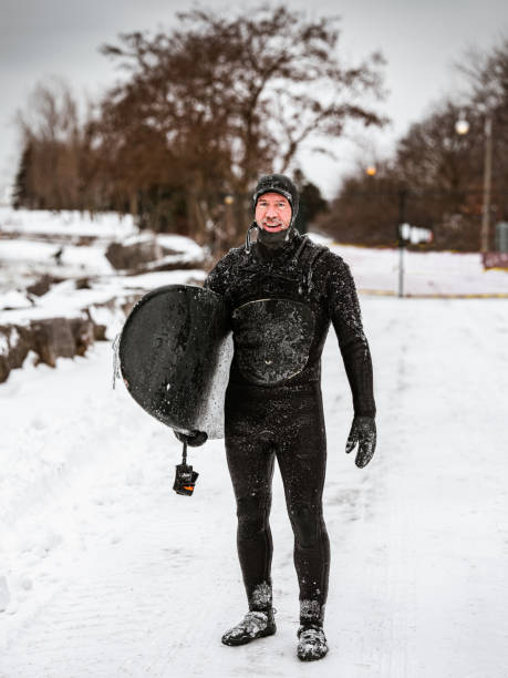 istock Mature man after surfing session in the winter 1302649325