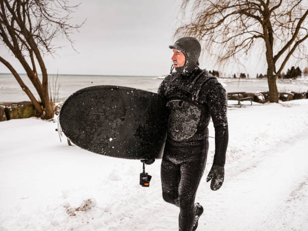 istock Mature man after surfing session in the winter 1302649357