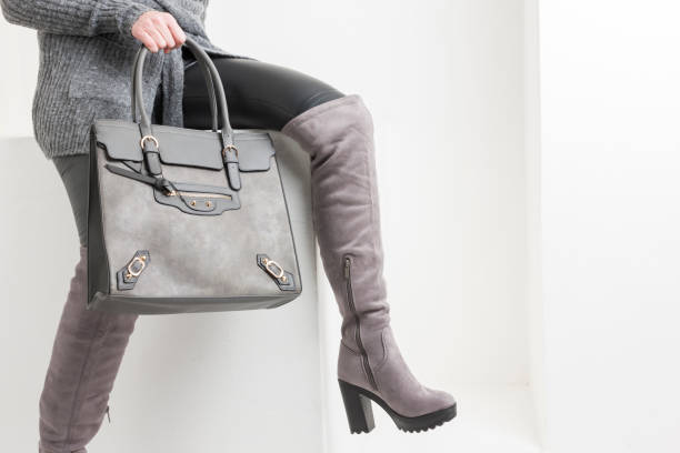 istock gray women's boots with a handbag 1302649376