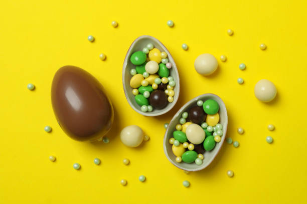 istock Easter chocolate eggs and candies on yellow background 1302650480