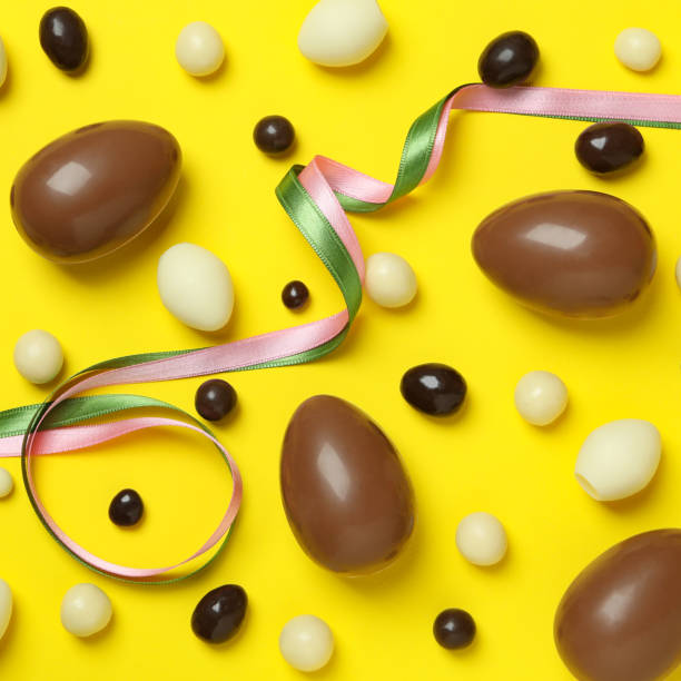 istock Easter chocolate eggs and candies on yellow background 1302651060