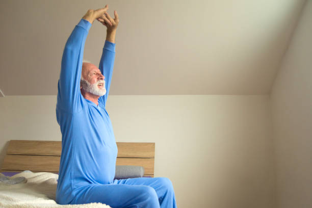 istock Senior man waking up in bed in the morning 1302652210