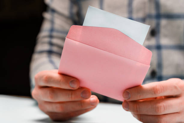istock A man holds a pink envelope and reads a love letter 1302652255