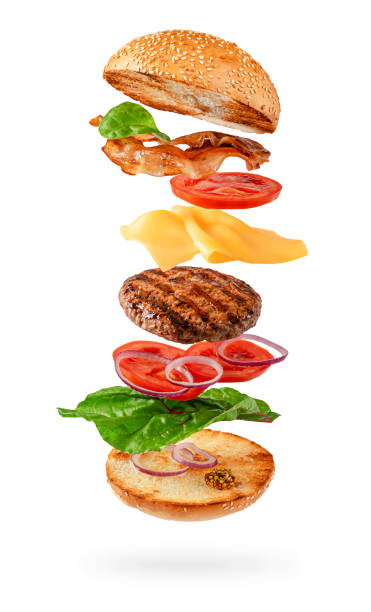 istock Maxi burger preparation with flying ingredients isolated on white background. Clipping path 1302652290