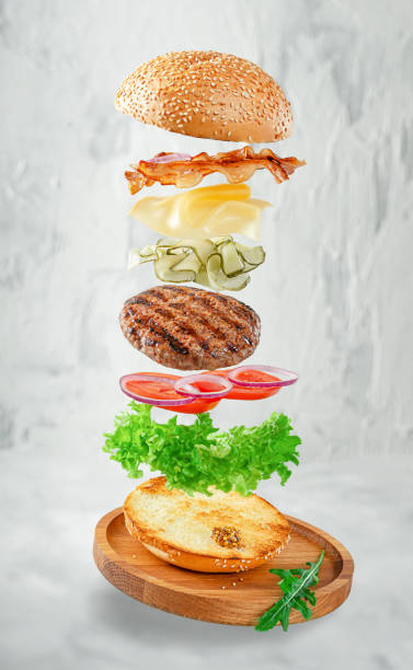 istock Flying hamburger on gray concrete background. Fast food concept 1302652326