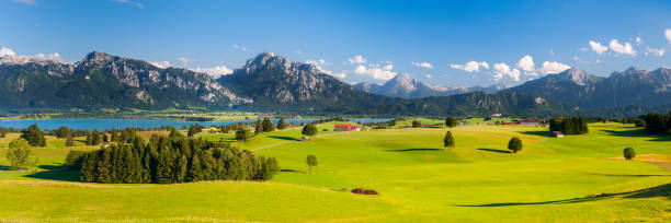 istock panoramic landscape with mountain range in Bavaria at springtime 1302652690