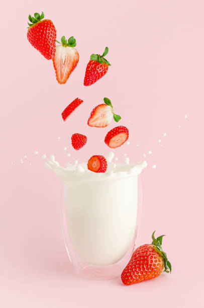 istock Falling strawberries into the glass with milk splash. Summer cocktail levitation concept. 1302653609