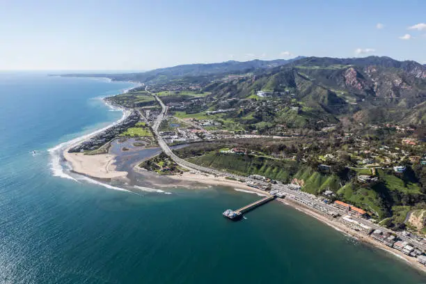 Aerial view of Malibu Pier, Surfrider Beach and the Santa Monica Mountains in Southern California.