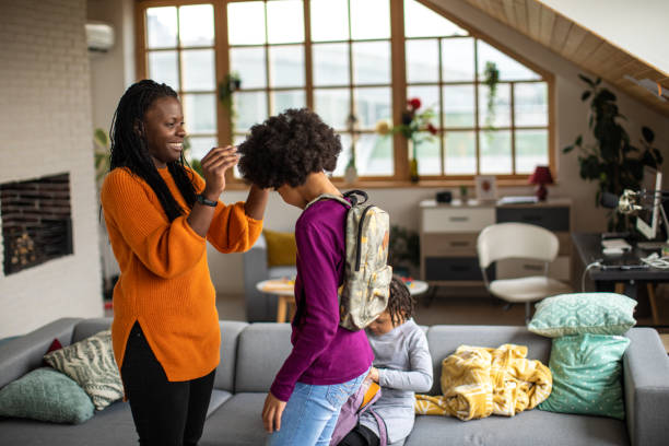 istock Mother making sure that everything is fine before her daughter go to school 1302654693