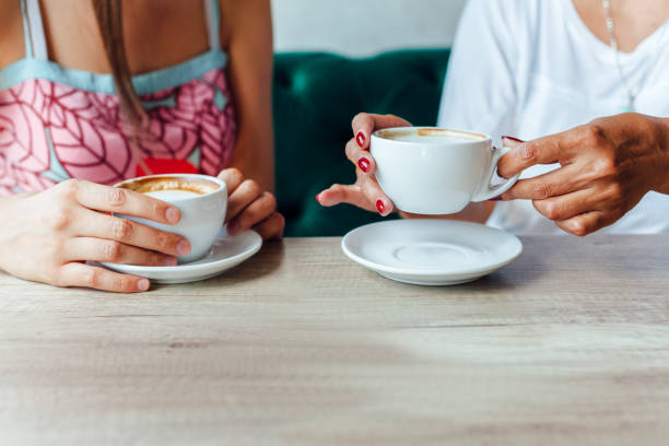 istock Mother And Daughter Enjoying Coffee 1302657002