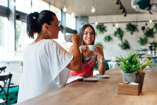 istock Two Women Drinking Coffee In A Cafe 1302657066