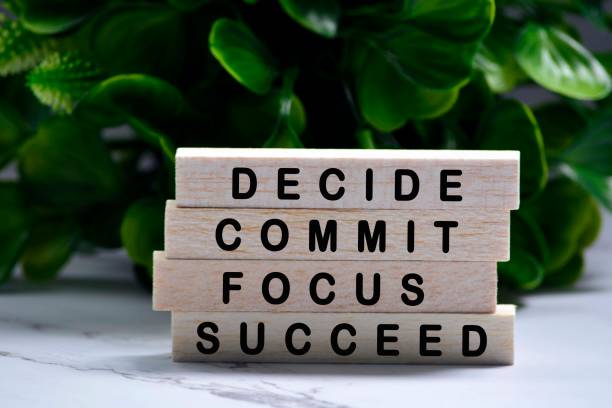 istock Inspirational words of decide commit focus succeed on wooden blocks with green background 1302657519