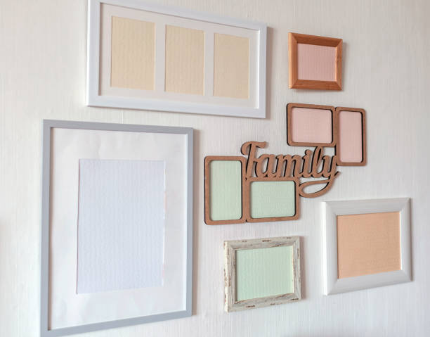 istock White wall with set of different empty vertical and horizontal frames to create family photo gallery 1302658542