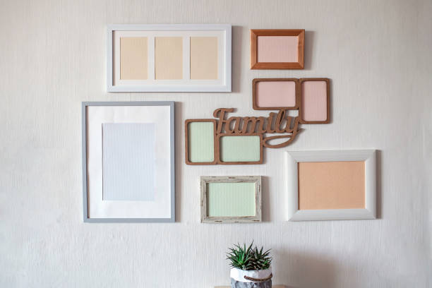 istock White wall with set of different empty vertical and horizontal frames to create family photo gallery 1302658558