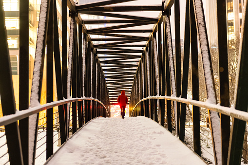 Lone Person crossing a bridge towards downtown Richmond