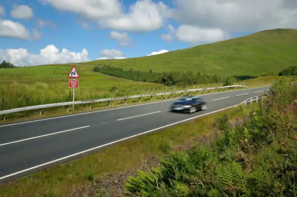 Roadster on the mountain road. Highlands, Scotland.