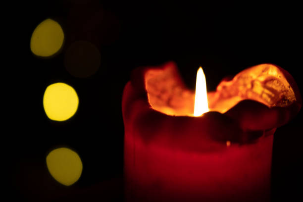 istock Red round candle burning with bokeh lights background 1302659774