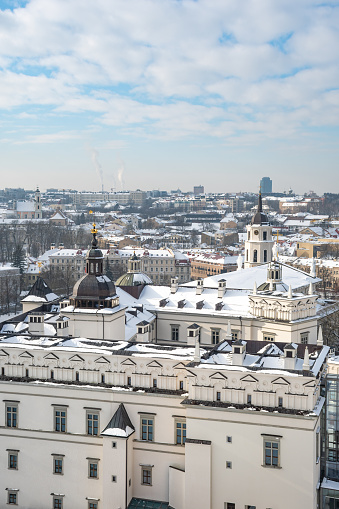 Aerial view of Vilnius old town, capital of Lithuania in winter day with roof covered by the snow, vertical
