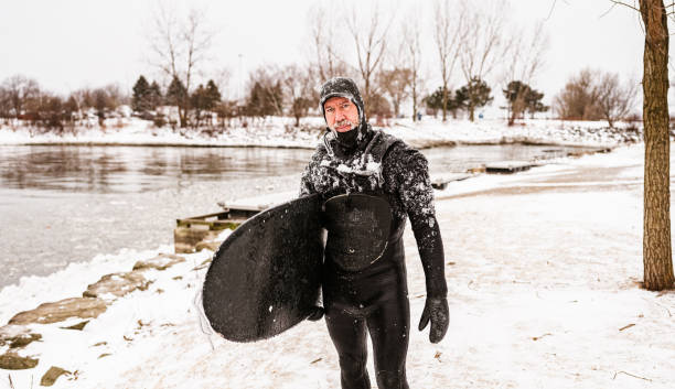 istock Mature man after surfing session in the winter 1302660977