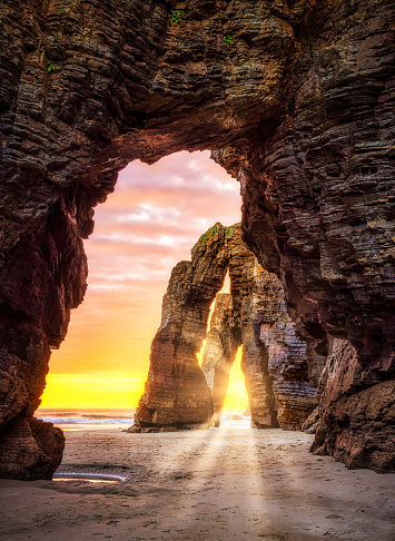 Natural rock arches in an Idyllic sunrise landscape in Cathedrals beach (playa de las catedrales), Ribadeo, Galicia, Spain