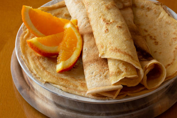istock Crepes with orange jam and oranges  - wooden background 1302661655