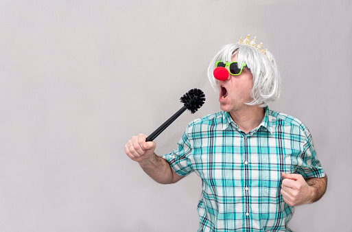 Mr Clown. Portrait of Funny face Clown man in colorful uniform standing holding copy space. Happy expression male bozo in various pose with frame mockup blank space on isolated background.