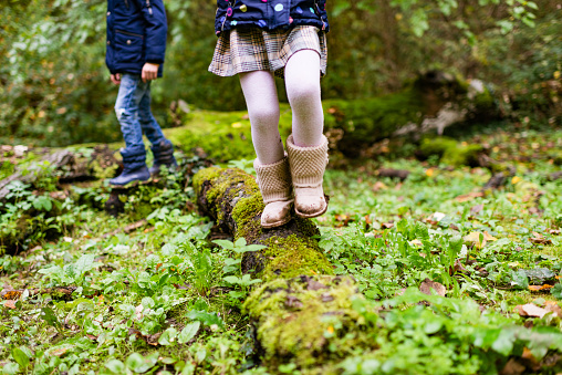 Young children exploring and relaxing in the nature. They are having fun.