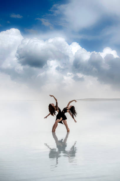 istock Beautiful ballerinas dancing on the lake 1302664897