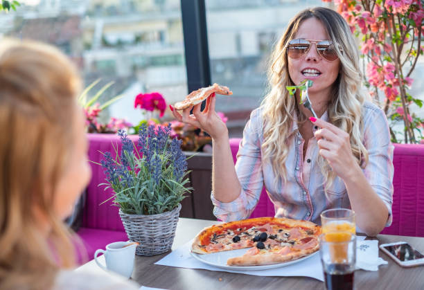 istock Two young women have a nice time in restaurant 1302665398