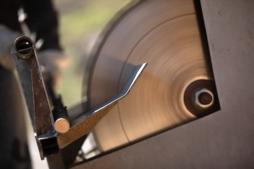 CU, Japanese man is cutting electrical materials with a tool.