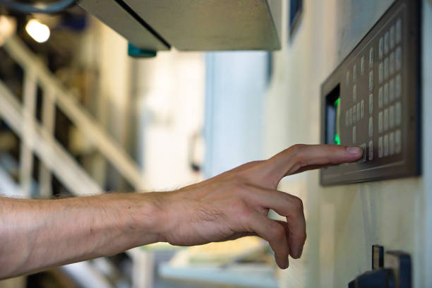 istock close up engineer hand finger press button controling cnc machine, Workers operating factory machinery in warehouse 1302668688