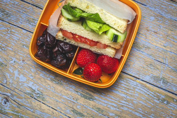 istock Sandwich in plastic container on wooden background 1302669008