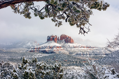 Scenic winter landscape view of Catherdral Rock with snow in Sedona, Arizona, USA.