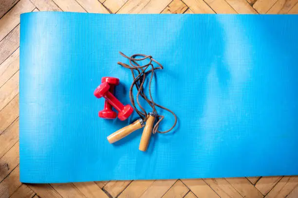Fitness at home. Home fitness with dumbbells and skipping rope. Top.
