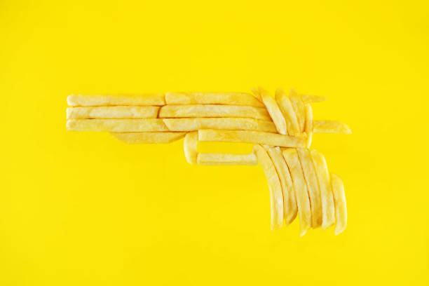 istock French fries gun on a yellow background 1302674047
