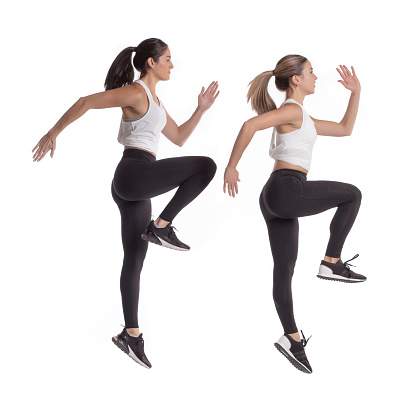 Two latin girls exercising on white background