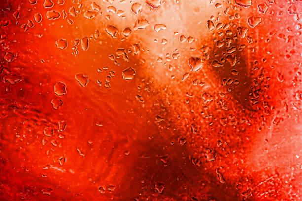 istock Abstract red background with blurred raindrops on glass, illuminated neon lights. Modern background 1302675901