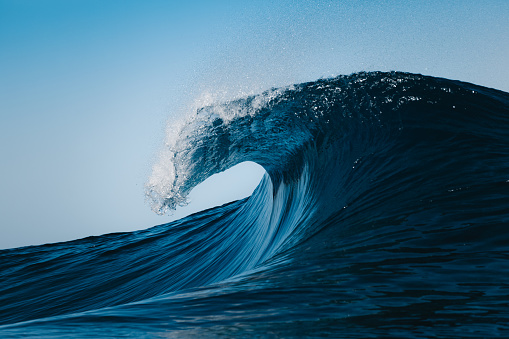 Blue wave breaking on a beach in sea in Las Palmas de Gran Canaria, CN, Spain